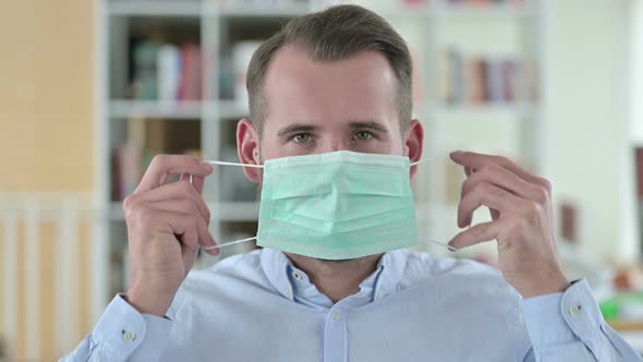 Portrait of Cautious Young Man with Face Mask 