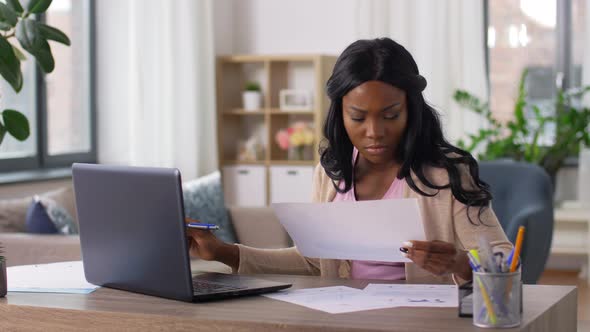 Stressed Woman with Papers Working at Home Office