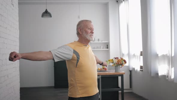 Health Care, an Elderly Attractive Man Goes in for Sports and Performs Exercises To Improve Body