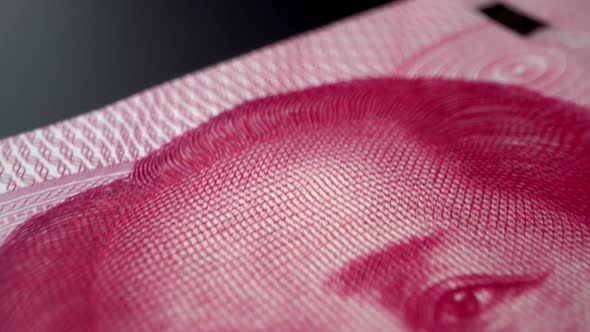 One hundred China Yuan paper banknote in close up macro view dolly shot.