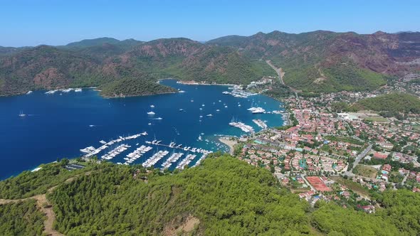 Small City Houses, Beautiful Marina and Touristic Boats in a Cove Surrounded by Forest by Sea