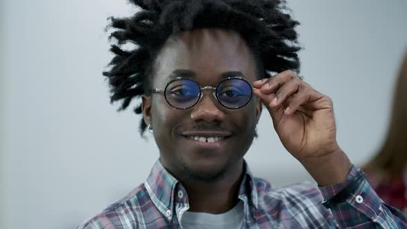 Close-up Face of Happy African American Man in Eyeglasses Looking at Camera and Smiling. Portrait of