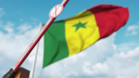 Closed Boom Gate with STOP CORONAVIRUS Sign at Flag of Senegal