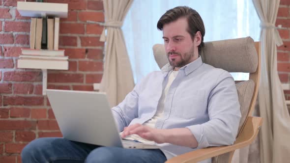 Casual Young Man Closing Laptop Leaving Sofa