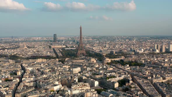 Rising dolly forward drone shot towards the Eiffel Tower Paris at sunset