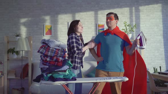 Joyful and Surprised Woman a Housewife and Man Superhero Who Ironed All the Clothes