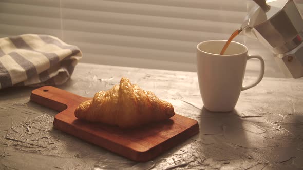 Food and Drink Concept. Morning Breakfast - Coffee and Croissant on a Table