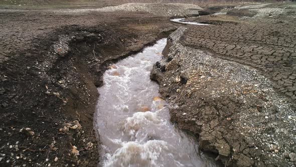 Landscape of dry earth ground and river