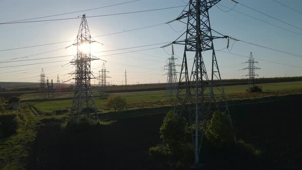 Aerial View of Electricity Pylons and High Voltage Power Line at Sunset