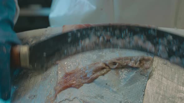 Curved blade used to scrape fatty meat from salmon skin