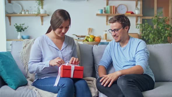 Ordering Gifts Online. A Man Gives a Woman a Gift that He Ordered Through the Site, an Online Store.