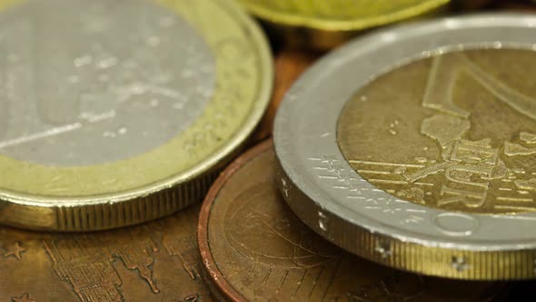 Macro shot of euro coins of different values: one uro, two euro, cents, etc. Macro shot, rotating vi