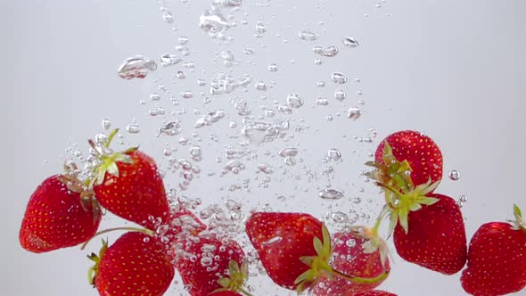 Ripe Strawberries Falling through the Water