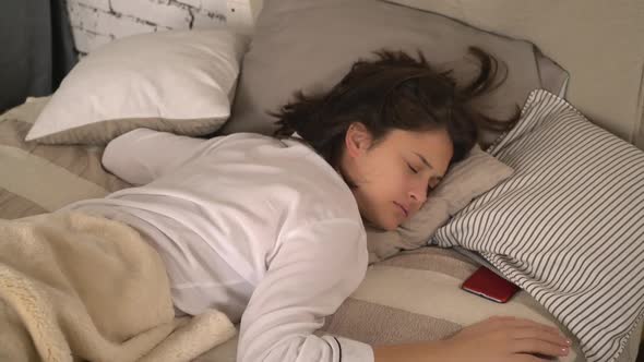 Adult Female Lying in Bed in Bedroom