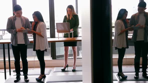 Business people discussing over digital tablet in a modern office 4k