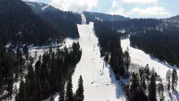 Aerial view approaching the ski slope at Poiana Brasov covered with snow