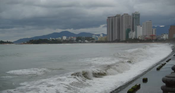 Cloudy Weather, Rain, Large Gray Clouds, Gloomy Weather, Sea Waves Break on the Shore of the City