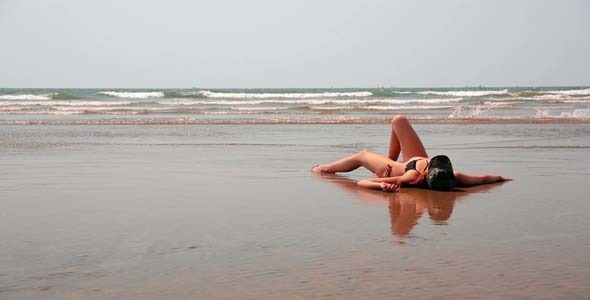 Young Woman Relaxing On Sandy Beach