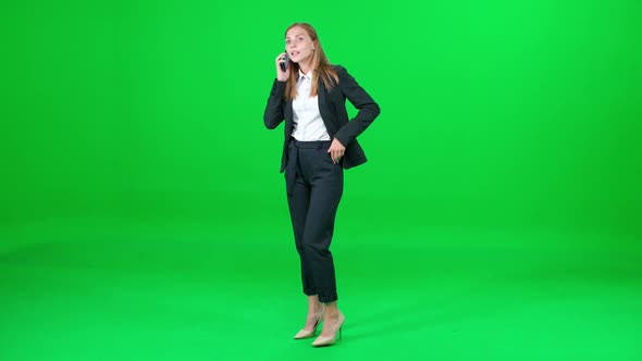 Female Businesswoman in a Suit Standing on Chroma Key Background Woman Talking on a Mobile Phone