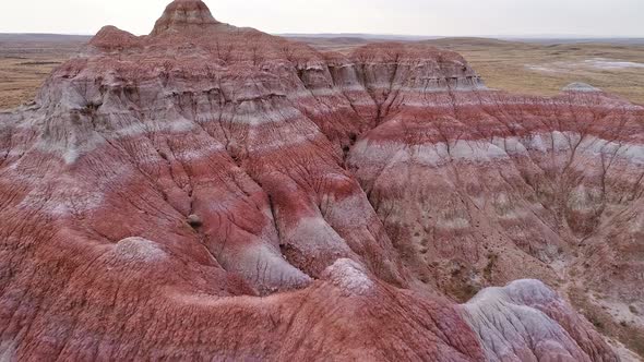 Flying over colorful red desert landscape hilltops in Wyoming