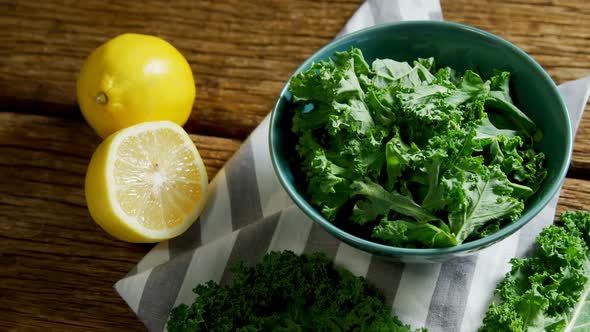 Green leafy vegetable in a bowl on wooden table 4k