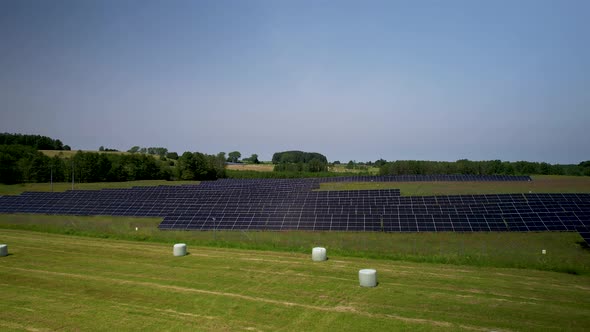 Solar field in rural area. Aerial shot of clean energy.
