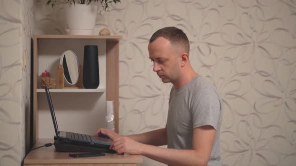 a Man Works on a Laptop