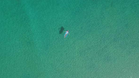 Woman lying on tropical transparent water