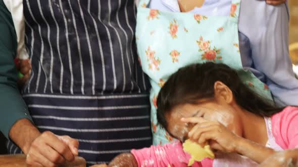 Family preparing cookies in kitchen