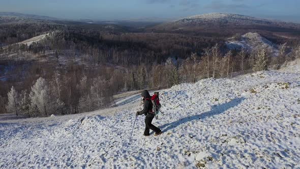 A Lonely Traveler Walks Along the Top of a Mountain Range