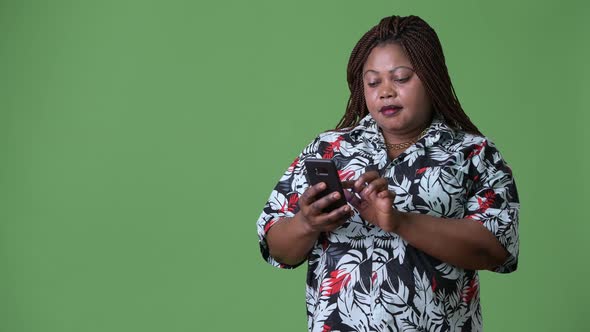 Overweight Beautiful African Woman Against Green Background