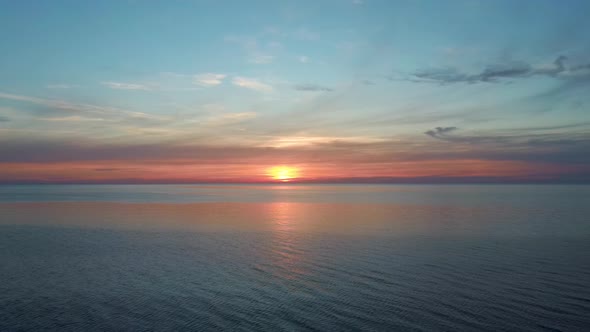 Dron Flying Backward Over Sea in a Beautiful Sunset. Colorful Sunset on the Baltic Sea, Latvia