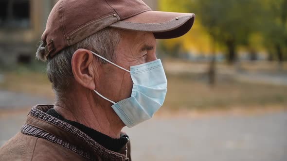 Close Up Portrait of Senior Man Wearing Protective Medical Face Mask