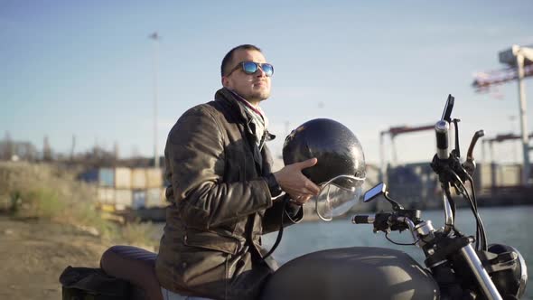 a Man Motorcyclist Wears a Helmet and Ride on His Motorcycle