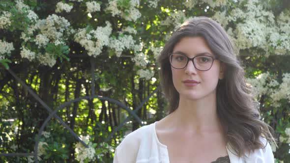 Slow motion shot of smiling brunette woman with glasses