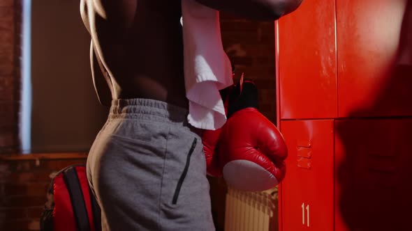 Africanamerican Athletic Halfnaked Young Man Opens Up His Locker and Puts in His Boxer Gloves