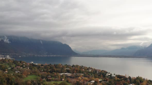 High pan over beautiful Lake Geneva with mountains at the background