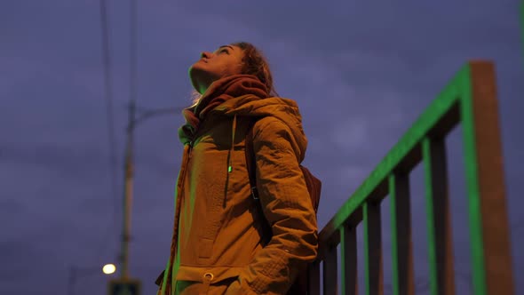 Woman Standing and Relaxing in the Night Winter City