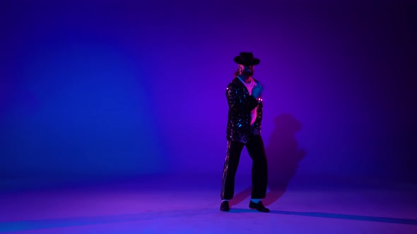 Young Stylish Teenager Is Showing Dance Moves Like Michael Jackson. Isolated Over Blue Background.