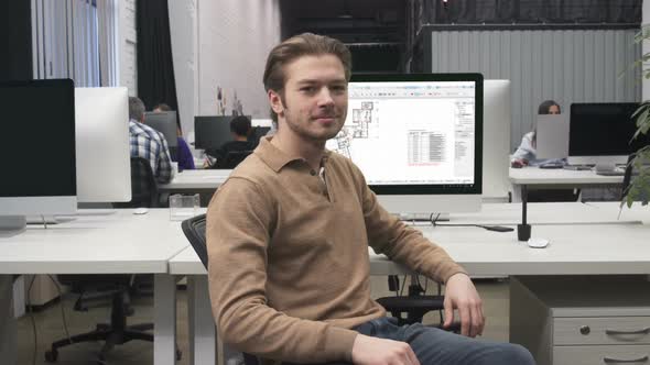 Happy Male Architect Worker At Workplace In Big Architectural Design Agency Office