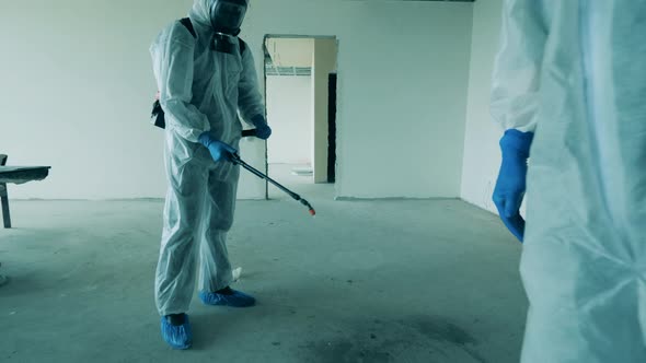 Sanitary Workers Are Sanitizing Unfinished Doorways