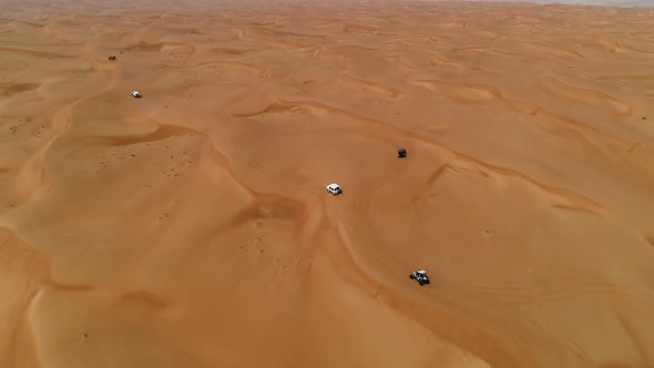 Aerial view group of car driving on a deserted landscape, U.A.E.