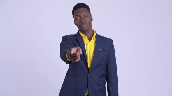 Young Happy African Businessman in Suit Pointing at Camera