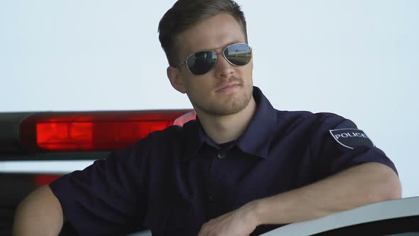 Handsome Cop in Sunglasses Smiling Standing Near Car, Reliable Police Service