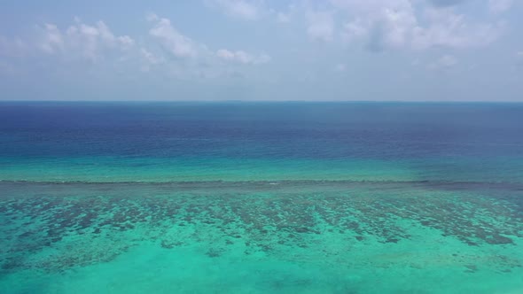 Aerial drone shot nature of tropical seashore beach lifestyle by blue green lagoon and white sandy b