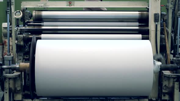 Large White Paper Roll On Industrial Printing Press.