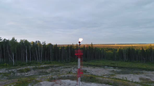 A Drone Flies Up to a Burning Torch at an Oil Field in the Swamps of Siberia