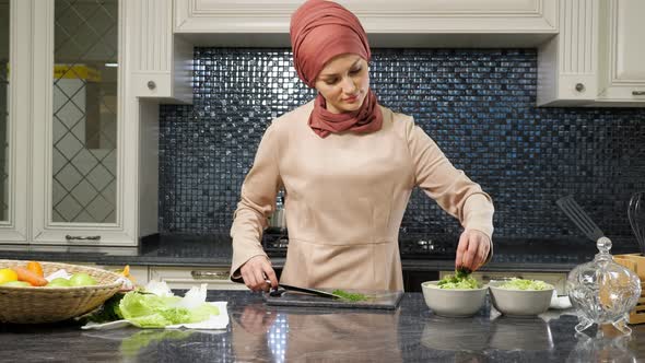 Muslim Woman Cooks Lunch for Family Cutting Greens Closeup