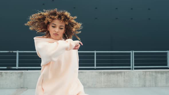 Fashionable Funky Curly Afro Dancer Woman in Sportswear Is Performing Outdoor Street Dancing Motion