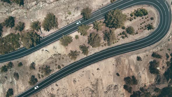 Top Down Aerial of Cars Drive Winding Highland Road in Mountain Countryside in Cyprus alt